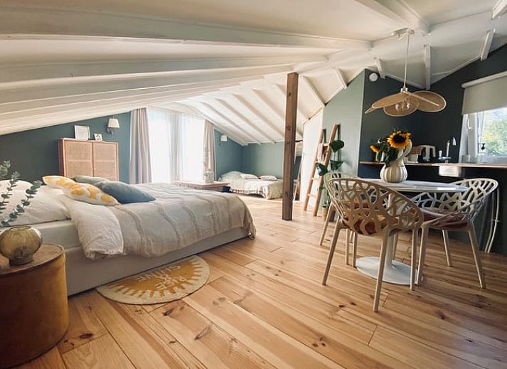 Spacious bedroom in Holiday Home in Fijnaart, North Brabant with wooden floor and cozy furnishings.