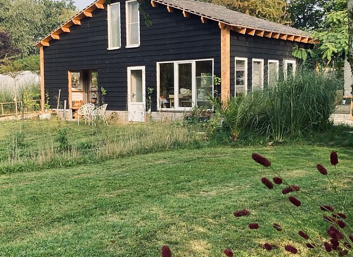 Spacious bedroom in Holiday Home in Fijnaart, North Brabant with wooden floor and cozy furnishings.