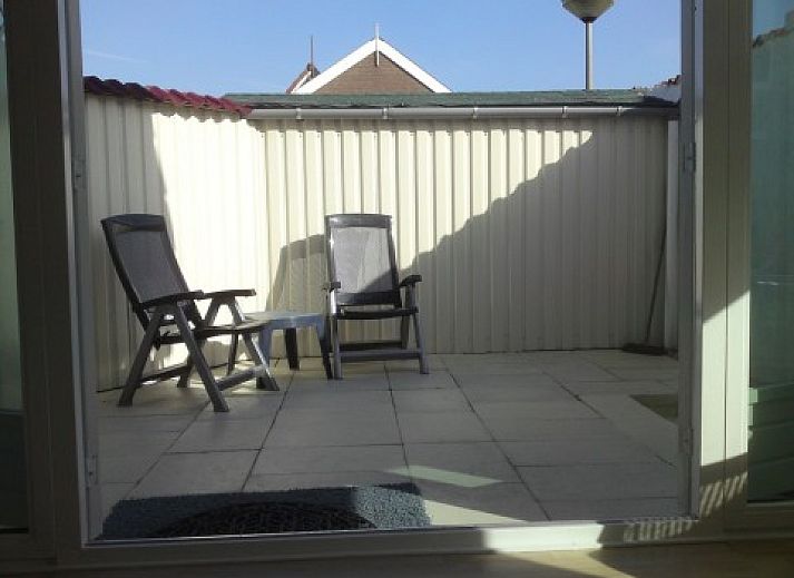 Lichte woonkamer in zomerhuis DEZEESTER, Egmond aan Zee, met comfortabele zithoek en moderne inrichting.