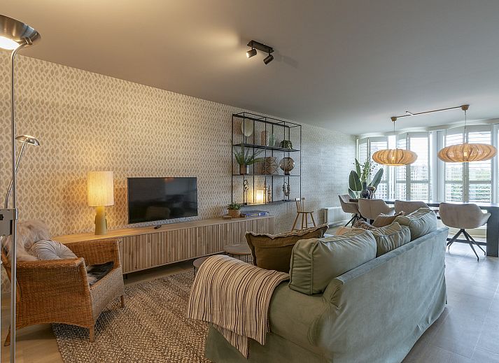 Dining room in Strandleven 006 Groote Keeten, Callantsoog with modern lighting and views of the North Sea coast.