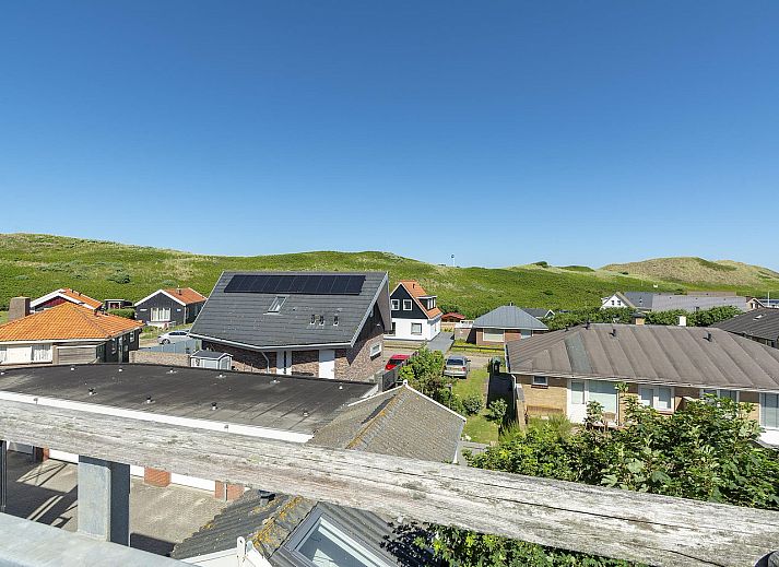 Sunny terrace at Dorpsplein 23E Callantsoog vacation home, overlooking dunes, North Sea coast, North Holland.