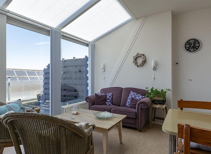 Sunny terrace at Dorpsplein 23E Callantsoog vacation home, overlooking dunes, North Sea coast, North Holland.