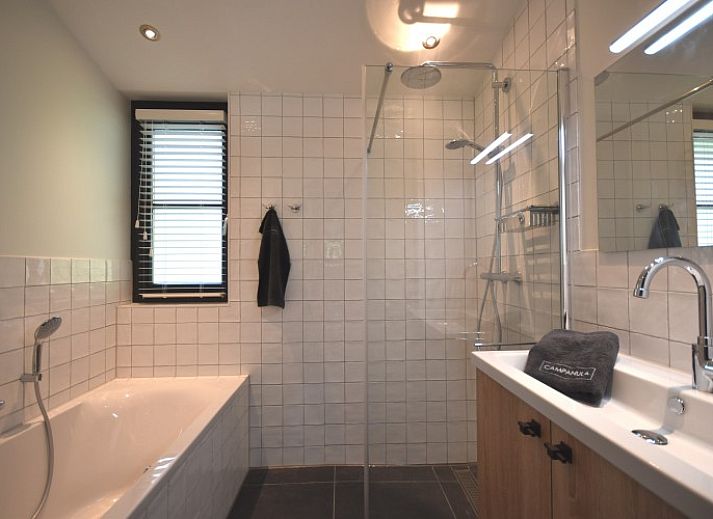 Beach villa bungalow in Sint Maartenszee with sunny terrace and green garden on the North Sea coast, North Holland.