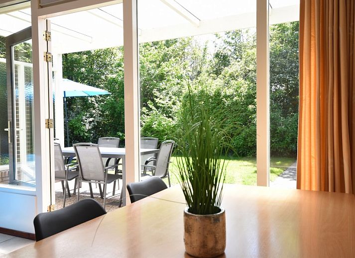 Cozy living room of Bungalow type D, sleeps 6 in Sint Maartenszee, North Sea coast, North Holland with large windows.