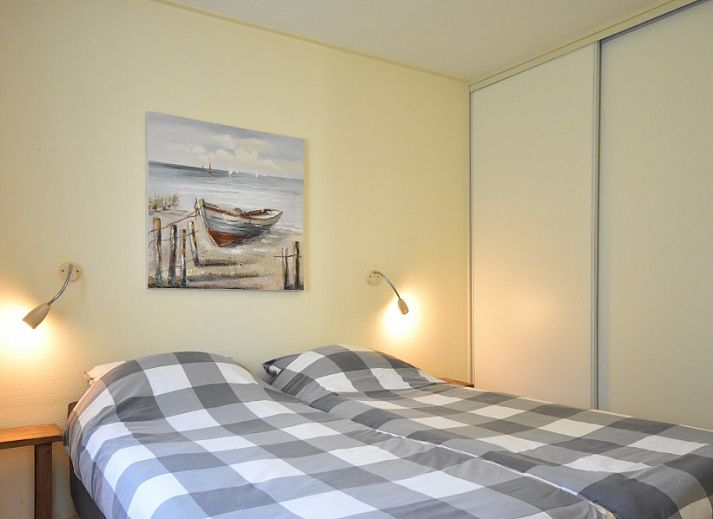 Cozy living room of Bungalow type D, sleeps 6 in Sint Maartenszee, North Sea coast, North Holland with large windows.