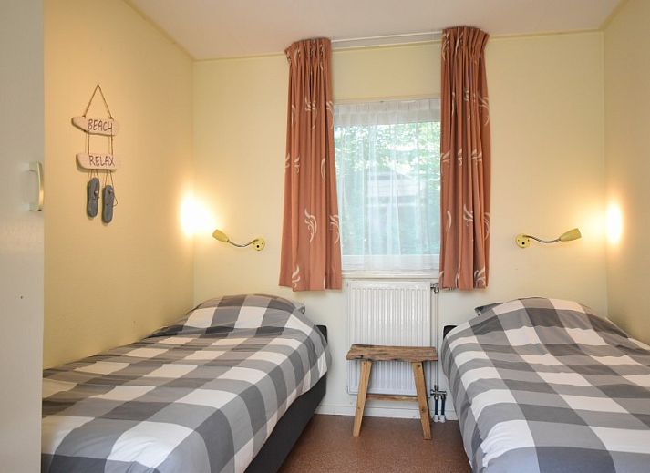 Cozy living room of Bungalow type D, sleeps 6 in Sint Maartenszee, North Sea coast, North Holland with large windows.