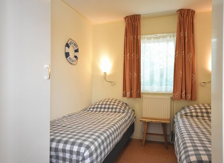 Cozy living room of Bungalow type D, sleeps 6 in Sint Maartenszee, North Sea coast, North Holland with large windows.