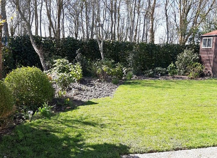 Veranda van vakantiehuis Rekere 111 in Schoorldam, Noordzeekust, Noord-Holland met zitgelegenheid en open deuren.