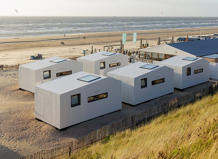 Modern kitchen and dining area in Beach House Sea 4, Zandvoort, North Sea coast, vacation home with stylish decor and natural light.
