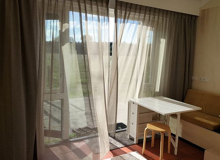 Bright living room with French doors in Holiday home in Castricum, North Sea coast, North Holland.