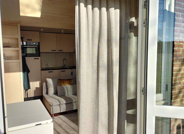Bright living room with French doors in Holiday home in Castricum, North Sea coast, North Holland.