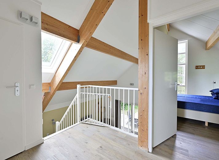 Ruime woonkamer met moderne inrichting in vakantiewoning Julianadorp aan Zee.