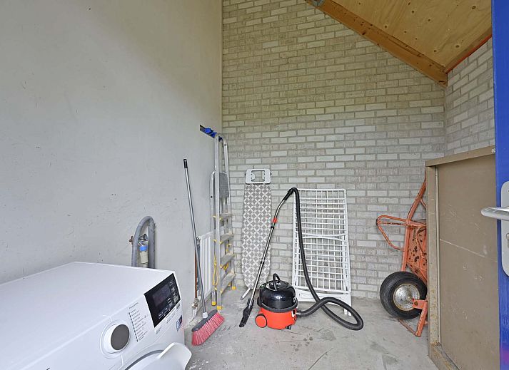 Gezellige zithoek met houten details in vakantiehuis Julianadorp aan Zee.