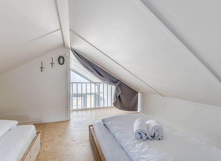 Interior space of Beach House 4-6 in Julianadorp aan Zee, North Holland, with modern furnishings and views of the North Sea coast.