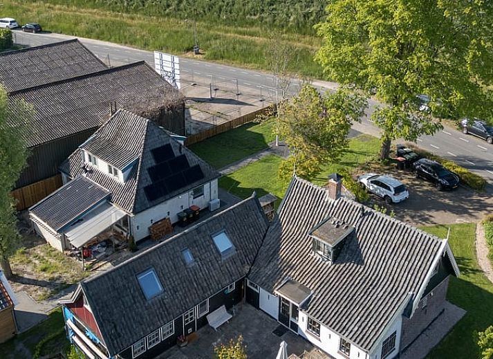 Charmante entree van Vakantiehuis in Andijk, met houten gevel in Noord-Holland, gelegen aan de serene IJsselmeerkust.