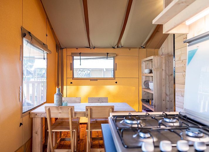 Enjoy yourself on the terrace of De Bos Tent, an attractive glamping lodge in Huizen, IJsselmeer coast, North Holland, with a cozy outdoor area.