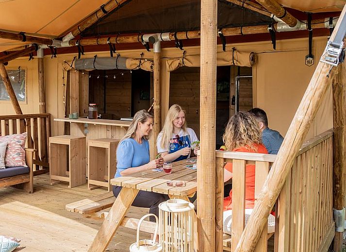 Enjoy the peace and quiet at De Heide Tent in Huizen, North Holland. This glamping lodge offers a cozy porch surrounded by nature.