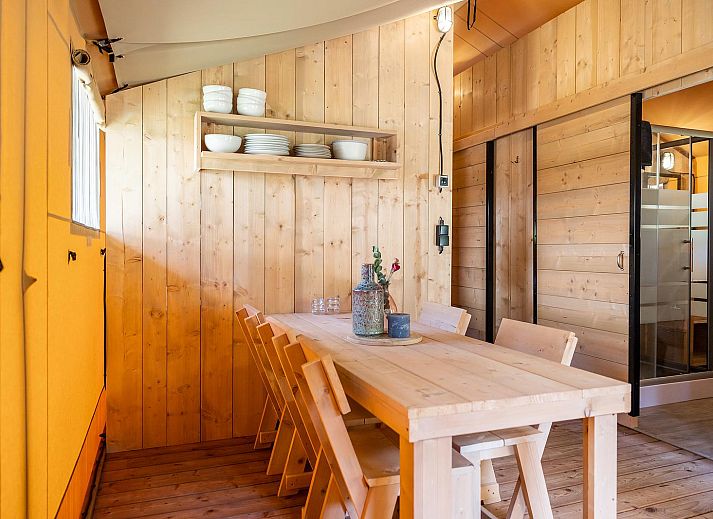 De Bos Tent in Huizen, IJsselmeer coast, North Holland offers an attractive glamping experience with a veranda and natural surroundings.