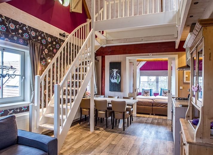 Cozy living room in Holiday Home in Oudesluis, North Holland with wooden beams and modern kitchen.