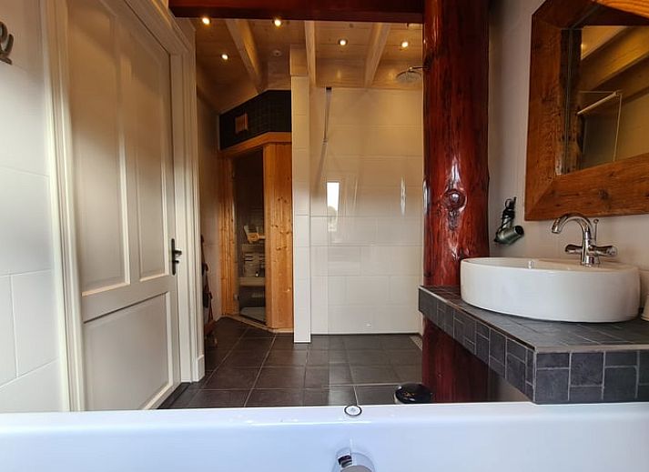 Dining area with stairs in Holiday home in Oudesluis, North Holland, perfect for family dinners.