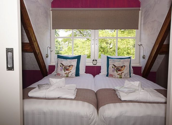 Dining area with stairs in Holiday home in Oudesluis, North Holland, perfect for family dinners.