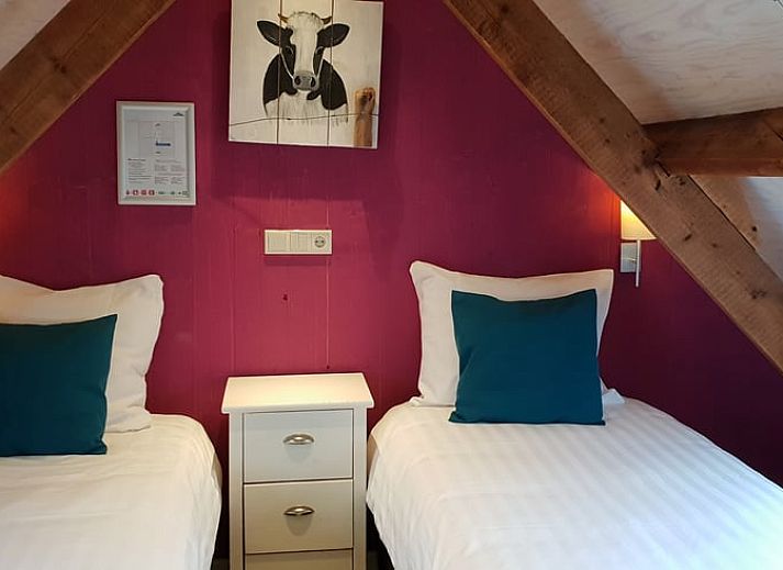 Relaxed reading by the window overlooking nature at Holiday Home in Oudesluis, North Holland.