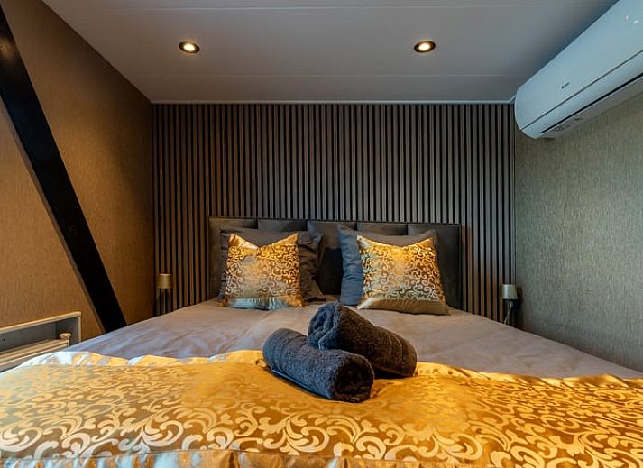 Eethoek in Vakantiehuisje in Nieuwe Niedorp met uitzicht op het terras en het serene water van Noord-Holland noord.