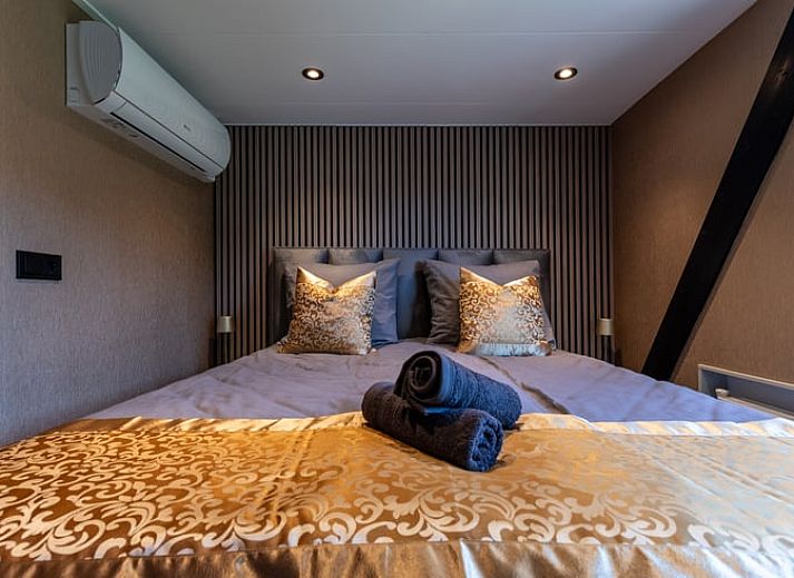 Eethoek in Vakantiehuisje in Nieuwe Niedorp met uitzicht op het terras en het serene water van Noord-Holland noord.