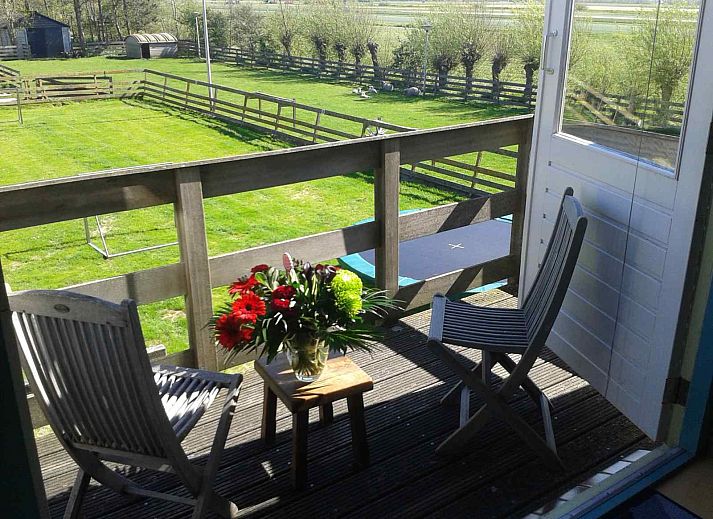 Green surroundings at vacation home NH351 in 't Zand, North Holland with playground for children.