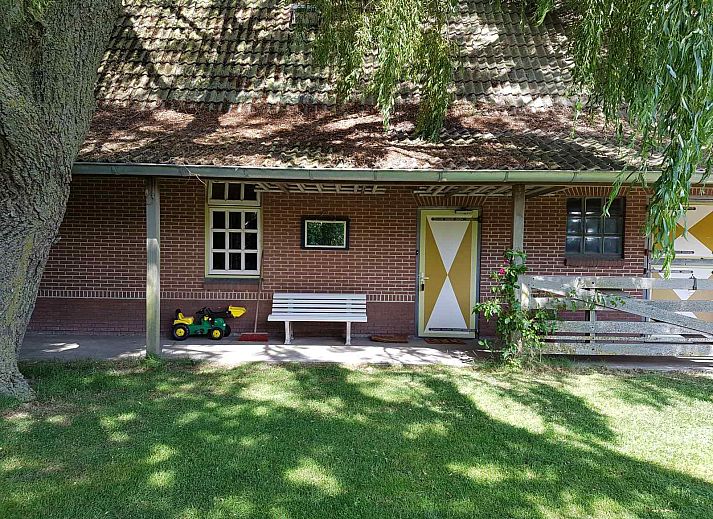 Green surroundings at vacation home NH351 in 't Zand, North Holland with playground for children.
