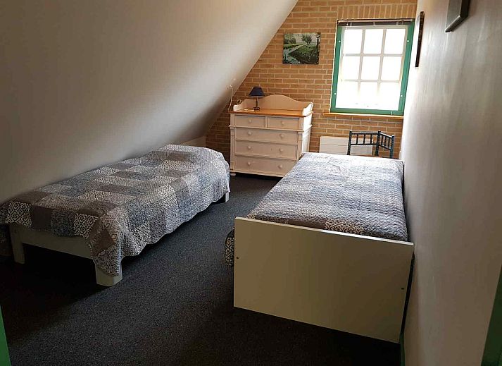 Comfortable bedroom in NH351 vacation home in 't Zand, North Holland with large window.