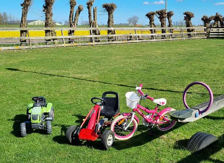 Comfortable bedroom in NH351 vacation home in 't Zand, North Holland with large window.