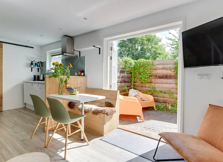 Ruhige Terrasse im Ferienhaus in Schoorl, Nordholland Nord, Nordholland, umgeben von ueppigem Gruen.