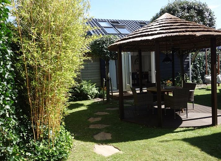 Moderne badkamer in Huisje in Schoorl, Noord-Holland met luxe douche en wasmachine, ideaal vakantiehuis voor comfort en ontspanning.