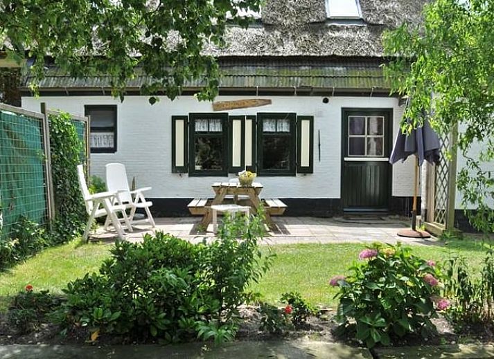 Enjoy the sunny terrace at Vakantiehuis in Schoorl, a charming vacation home in the green surroundings of North Holland North.
