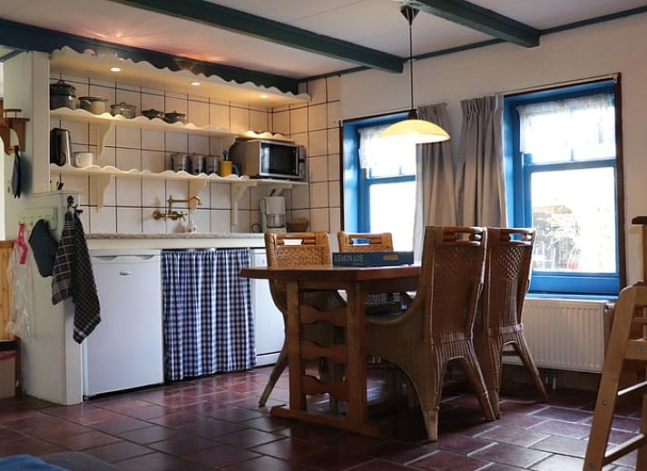 Enjoy the sunny terrace at Vakantiehuis in Schoorl, a charming vacation home in the green surroundings of North Holland North.