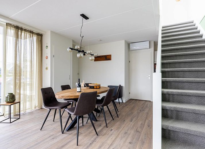 Geniessen Sie die Terrasse des Lakehouse I in Uitgeest, Nordholland, mit Blick auf den Yachthafen und den komfortablen Innenbereich dieses Ferienhauses.