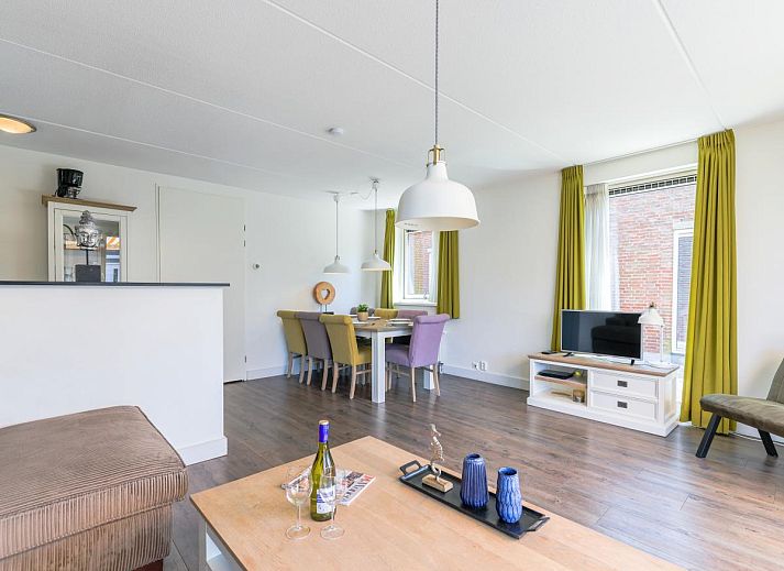 Enjoy the sunny terrace of the Assum Great vacation home in Uitgeest, North Holland, with a view of the water and modern outdoor space.