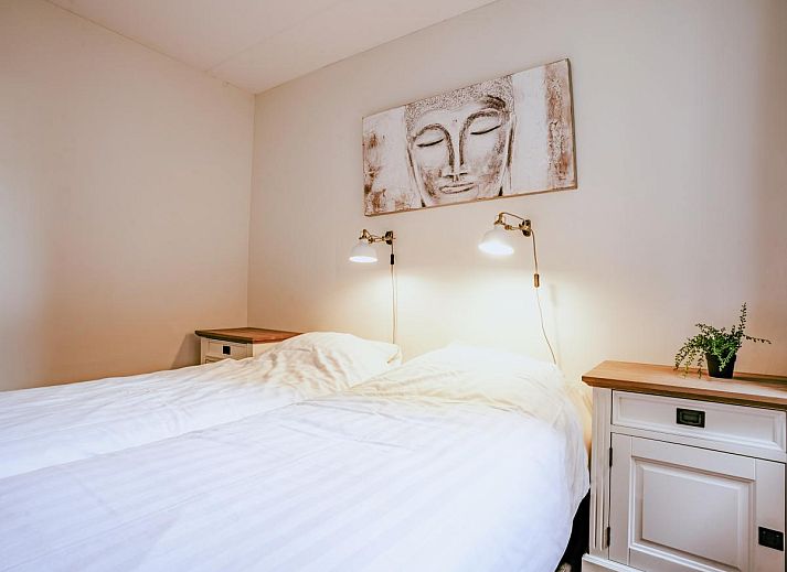 Spacious living room of Apartment Assum I in Uitgeest, North Holland, with a view of the terrace and modern furnishings for a relaxing stay.