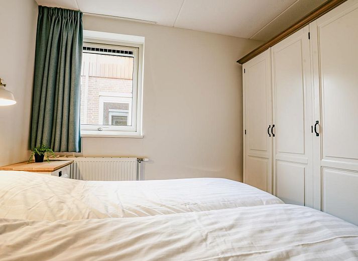 Spacious living room of Apartment Assum I in Uitgeest, North Holland, with a view of the terrace and modern furnishings for a relaxing stay.