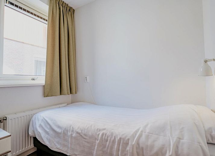 Spacious living room of Apartment Assum I in Uitgeest, North Holland, with a view of the terrace and modern furnishings for a relaxing stay.