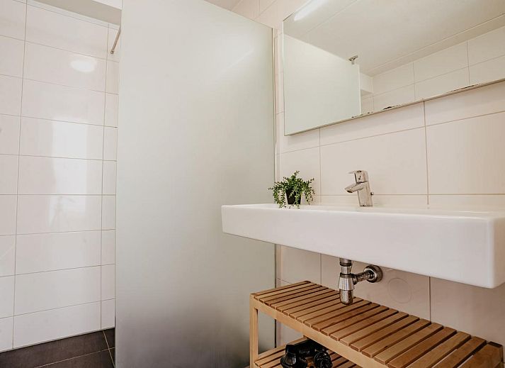Cozy living room of Apartment Assum I in Uitgeest, North Holland, with comfortable seating area and view of the sunny terrace.