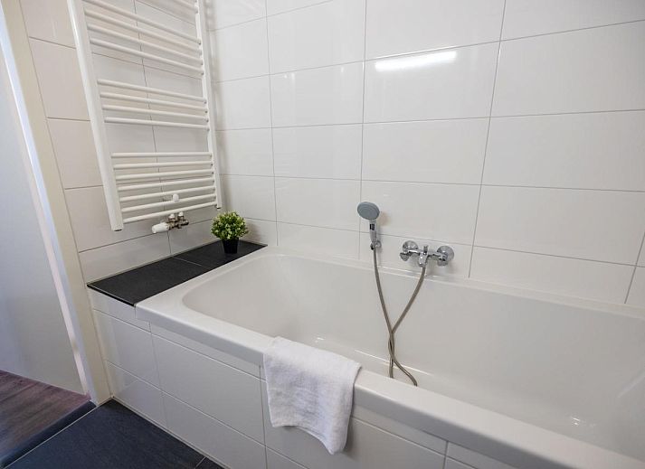 Cozy living room of Apartment Assum I in Uitgeest, North Holland, with comfortable seating area and view of the sunny terrace.