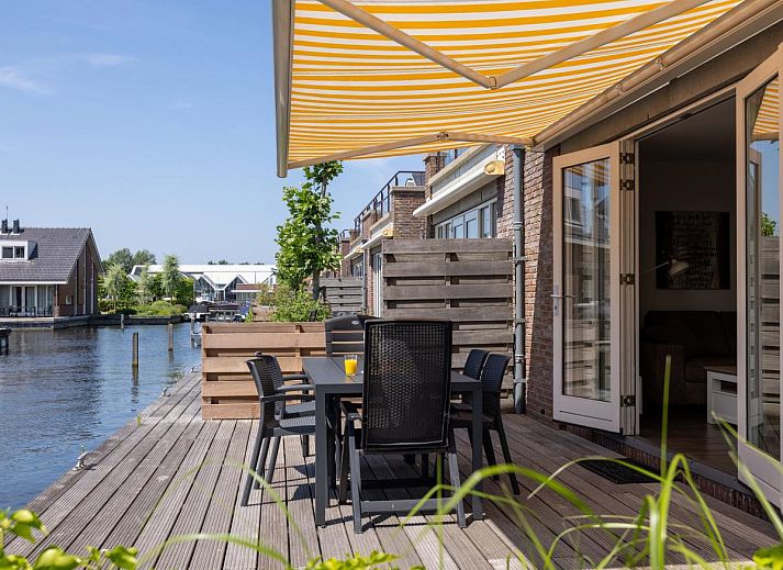Cozy living room of Apartment Assum I in Uitgeest, North Holland, with comfortable seating area and view of the sunny terrace.