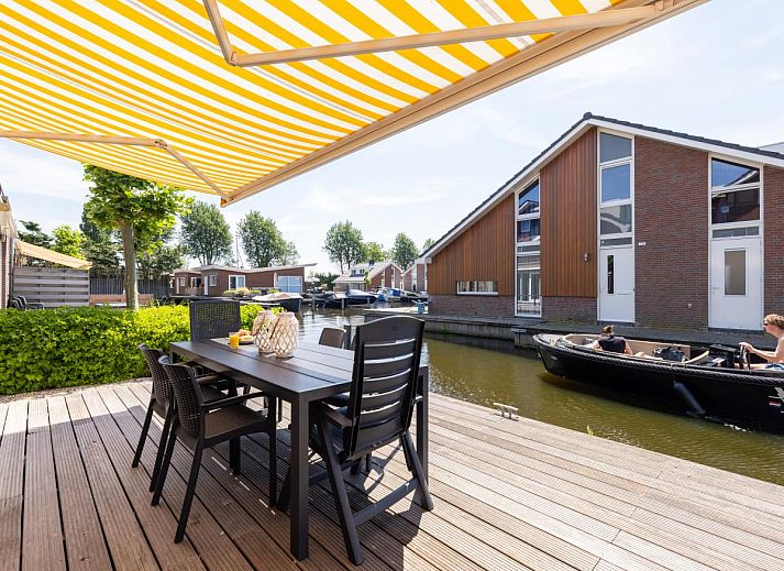 Cozy living room of Apartment Assum I in Uitgeest, North Holland, with comfortable seating area and modern kitchen.