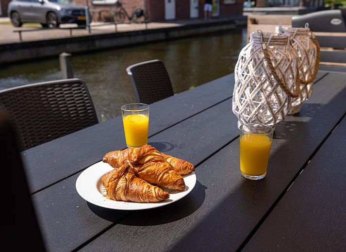 Cozy living room of Apartment Assum I in Uitgeest, North Holland, with comfortable seating area and modern kitchen.