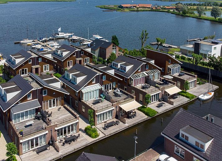 Cozy living room of Apartment Assum I in Uitgeest, North Holland, with comfortable seating area and modern kitchen.