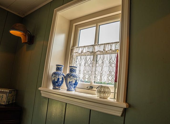 Alpakas werden in der gruenen Umgebung von Huisje in Ursem, einem Ferienhaus in Nordholland, gefuettert.