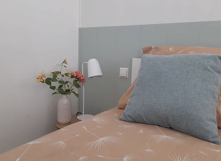 Cozy living room in Holiday Home in Driehuizen, North Holland, with comfortable sofa and garden view.