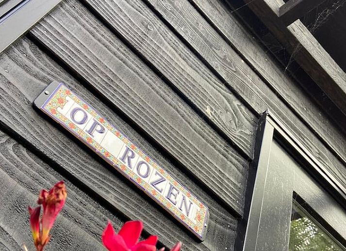 Cozy living room in Holiday Home in Driehuizen, North Holland, with comfortable sofa and garden view.